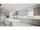 Modern kitchen with gray cabinets, quartz countertops, and herringbone backsplash at 10426 Longmeadow Ave, Parrish, FL 34219