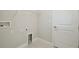 Bright laundry room with built-in shelving and washer/dryer hookups at 10426 Longmeadow Ave, Parrish, FL 34219