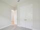Bright bedroom with double doors leading to the closet and another room at 10422 Longmeadow Ave, Parrish, FL 34219