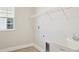 Laundry room with utility sink, shelving and window at 10422 Longmeadow Ave, Parrish, FL 34219