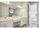 Double vanity bathroom with modern finishes and access to bedroom at 10422 Longmeadow Ave, Parrish, FL 34219