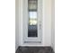 Front entry with light-colored door and paver walkway at 10422 Longmeadow Ave, Parrish, FL 34219