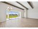 Spacious dining area with hardwood floors, exposed wooden beams, and access to backyard at 10422 Longmeadow Ave, Parrish, FL 34219