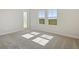 Bright bedroom with plush carpet, door to backyard, and large windows at 10422 Longmeadow Ave, Parrish, FL 34219