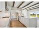 Open concept kitchen with white cabinets, large island, and stainless steel appliances at 10422 Longmeadow Ave, Parrish, FL 34219