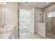 Bathroom with shower, double vanity, and view of bedroom at 10422 Longmeadow Ave, Parrish, FL 34219