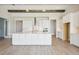 Open concept kitchen with white cabinets, large island and stainless steel appliances at 10422 Longmeadow Ave, Parrish, FL 34219