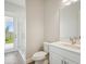 Bathroom with a glass shower, toilet, and modern vanity at 10422 Longmeadow Ave, Parrish, FL 34219