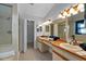 Bright bathroom with double sinks, wood countertops, walk-in shower, and large closet at 2618 Crestfield Dr, Valrico, FL 33596
