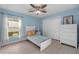 Bright bedroom with wood floors, a ceiling fan, and a large window at 2618 Crestfield Dr, Valrico, FL 33596
