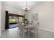 Dining room with wood floors, a chandelier, and sliding door access to the outdoor patio at 2618 Crestfield Dr, Valrico, FL 33596