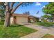 Well-maintained home exterior with a large garage and a charming front lawn, showcasing curb appeal at 2618 Crestfield Dr, Valrico, FL 33596