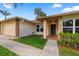 Charming single-Gathering home featuring well-kept landscaping, a brick accent wall and a two-car garage at 2618 Crestfield Dr, Valrico, FL 33596