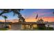 Charming home exterior with brick accents and a beautiful sunset backdrop at 2618 Crestfield Dr, Valrico, FL 33596