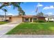 Charming single-story home with a well-manicured lawn, brick accents, and a two-car garage at 2618 Crestfield Dr, Valrico, FL 33596