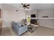 Cozy living room featuring a fireplace, ceiling fan, and views of the lush backyard at 2618 Crestfield Dr, Valrico, FL 33596
