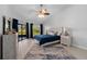 Comfortable main bedroom with wood floors and large windows providing natural light at 2618 Crestfield Dr, Valrico, FL 33596