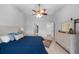 Bright main bedroom with a ceiling fan, light wood floors, and a decorative headboard at 2618 Crestfield Dr, Valrico, FL 33596