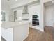 Modern kitchen with white cabinets and quartz countertops at 13150 Homestead Ln, Parrish, FL 34219