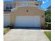 Townhouse exterior with a double-car garage at 277 Valencia Cir, St Petersburg, FL 33716