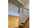 Elegant staircase with wooden railing and modern light fixture at 277 Valencia Cir, St Petersburg, FL 33716