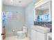 Updated bathroom with white vanity and blue-themed shower at 1826 Wolf Laurel Dr, Sun City Center, FL 33573