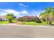 House with red tile roof and lush landscaping at 1826 Wolf Laurel Dr, Sun City Center, FL 33573
