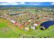 Aerial view showing home's location in a neighborhood near a golf course and lake at 1826 Wolf Laurel Dr, Sun City Center, FL 33573