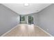 Spacious bedroom with wood-look flooring and access to a patio at 1826 Wolf Laurel Dr, Sun City Center, FL 33573