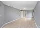 Large bedroom with wood-look flooring and access to the bathroom at 1826 Wolf Laurel Dr, Sun City Center, FL 33573