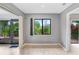 Bright dining room with wood-look floors and view of lush landscaping at 1826 Wolf Laurel Dr, Sun City Center, FL 33573