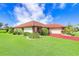 Single-story home with red tile roof and well-manicured lawn at 1826 Wolf Laurel Dr, Sun City Center, FL 33573