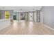Bright living room featuring light wood laminate flooring and an open floor plan at 1826 Wolf Laurel Dr, Sun City Center, FL 33573
