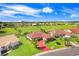 Aerial view showcasing a house with red roof and a red driveway at 1826 Wolf Laurel Dr, Sun City Center, FL 33573