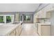 Modern kitchen with white cabinets, tile countertops, and stainless steel appliances at 1826 Wolf Laurel Dr, Sun City Center, FL 33573