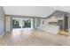Spacious living room with light wood floors and access to patio at 1826 Wolf Laurel Dr, Sun City Center, FL 33573