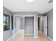 Bedroom with mirrored closet doors and light grey walls at 1826 Wolf Laurel Dr, Sun City Center, FL 33573