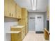Laundry room with wood cabinets and additional storage at 1826 Wolf Laurel Dr, Sun City Center, FL 33573