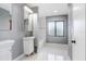 Modern bathroom with white vanity, tile flooring and a soaking tub at 1826 Wolf Laurel Dr, Sun City Center, FL 33573