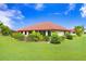 Backyard view of home with tropical landscaping at 1826 Wolf Laurel Dr, Sun City Center, FL 33573