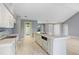 Spacious kitchen boasts white cabinets, granite countertops and an island at 1826 Wolf Laurel Dr, Sun City Center, FL 33573