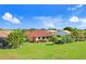 Aerial view of home with red tile roof and green lawn at 1826 Wolf Laurel Dr, Sun City Center, FL 33573