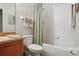 Full bathroom with tub, shower, and green accents at 7443 Surrey Wood Ln, Apollo Beach, FL 33572