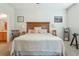 Main bedroom with king-size bed, wood headboard, and neutral decor at 7443 Surrey Wood Ln, Apollo Beach, FL 33572