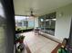 Spacious screened porch with tile floor and outdoor seating at 7443 Surrey Wood Ln, Apollo Beach, FL 33572