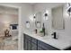Bathroom with a double sink vanity, decorative mirrors and modern light fixtures at 120 Chesapeake Ave, Tampa, FL 33606