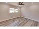 Clean, well-lit bedroom featuring a modern ceiling fan, neutral paint, white trim, and wood-look flooring at 120 Chesapeake Ave, Tampa, FL 33606