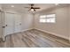 Well-lit bedroom includes wood-look flooring, modern ceiling fan, window with backyard view, and closet at 120 Chesapeake Ave, Tampa, FL 33606