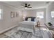 Comfortable bedroom with a ceiling fan, two windows and a gray headboard at 120 Chesapeake Ave, Tampa, FL 33606