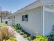 Light blue exterior wall with brick and landscaping leading to the side of the property at 120 Chesapeake Ave, Tampa, FL 33606